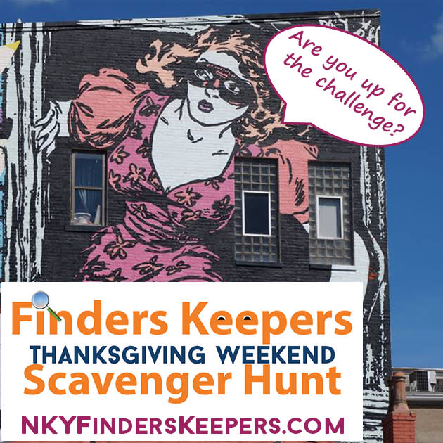 The Faile mural in Covington Kentucky of a cat burglar with the words, Are you up for the challenge? for the Thanksgiving scavenger hunt
