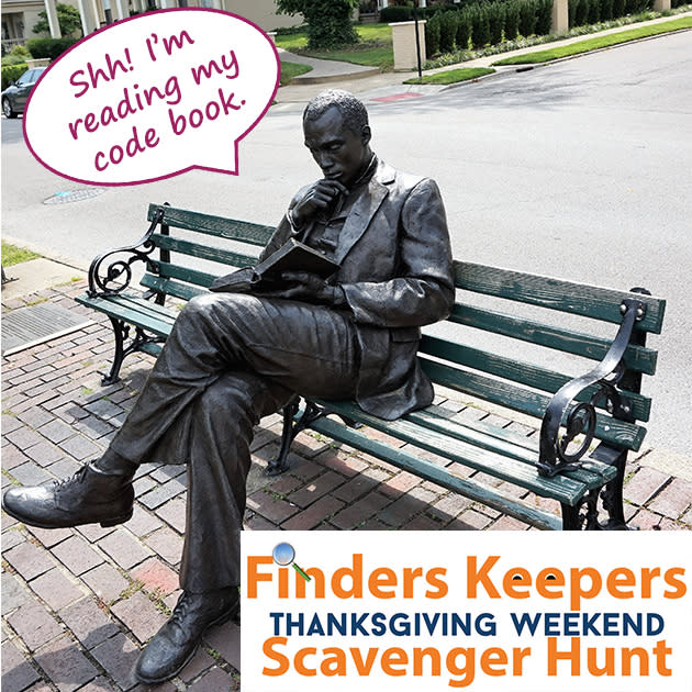 James Bradley statue in Covington Kentucky with the words Shh! I'm reading my code book. For the local Thanksgiving Scavenger Hunt