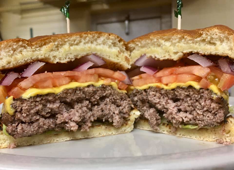 thick burger with onions tomatoes and cheese at brickhouse pub and grub in florence ky