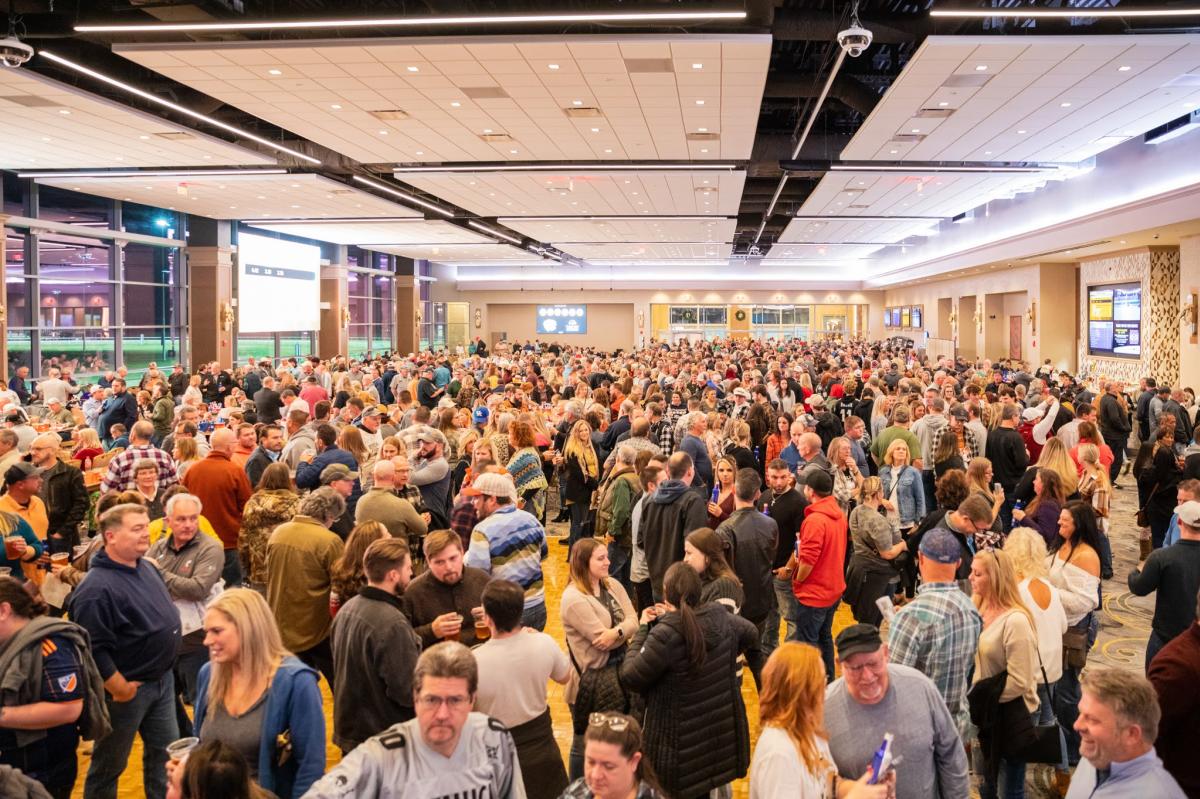 Image is of thousands of people inside the Turfway Park Racing and Gaming viewing room.