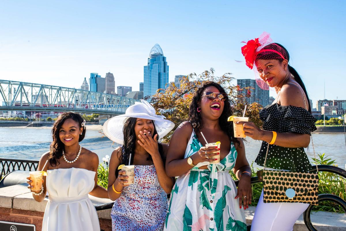 Image is of 4 ladies dressed in Derby attire at Newport on the Levee.
