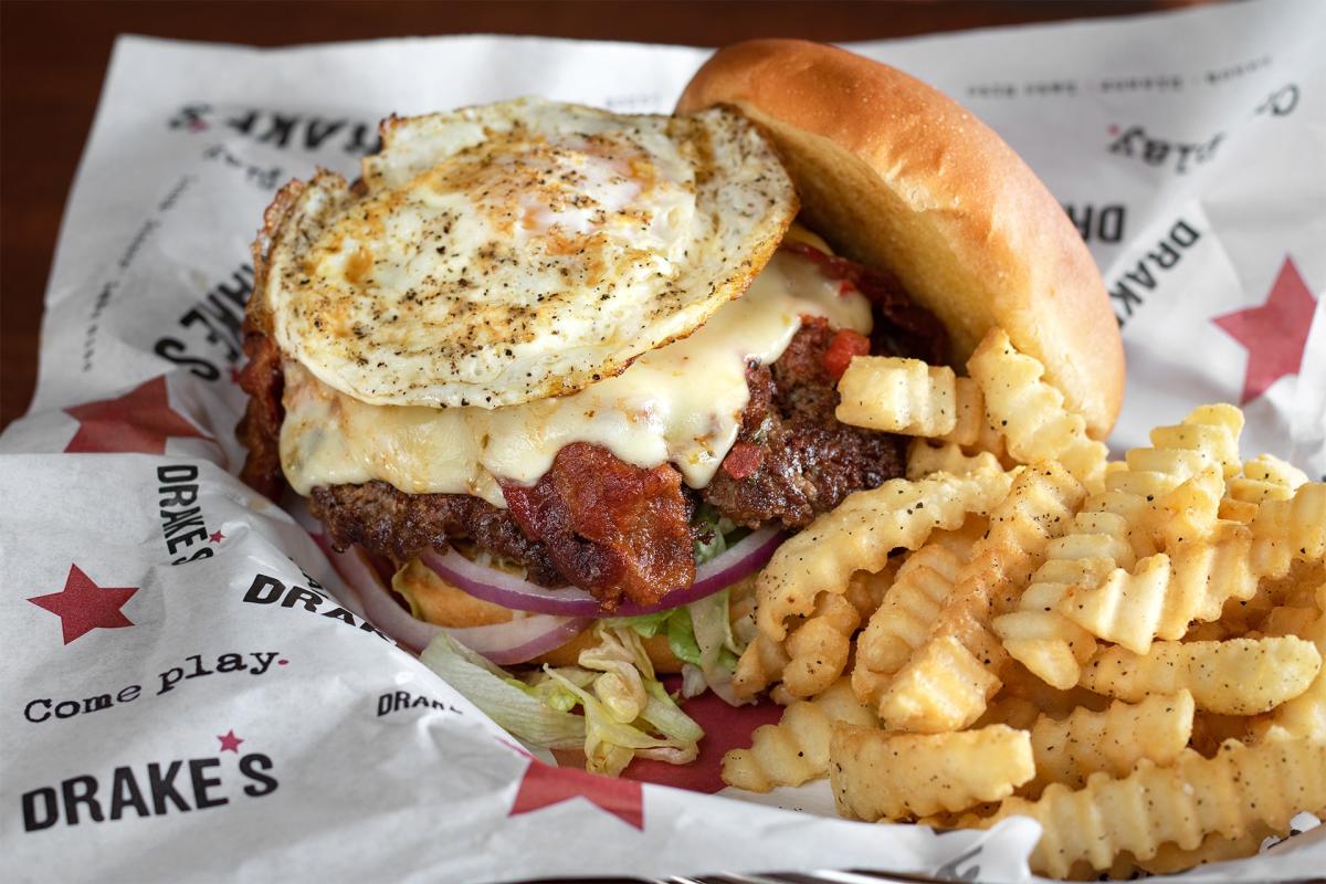 cheeseburger with fried egg and side of fries from drake's florence ky