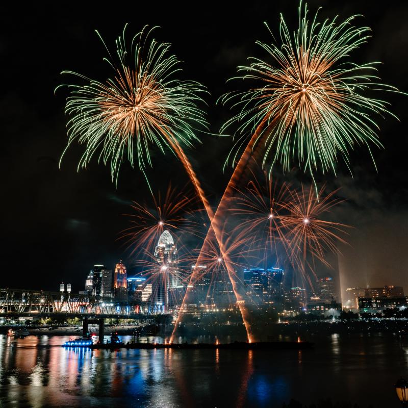 Gold and green fireworks burst in the sky high above the Cincinnati skyline