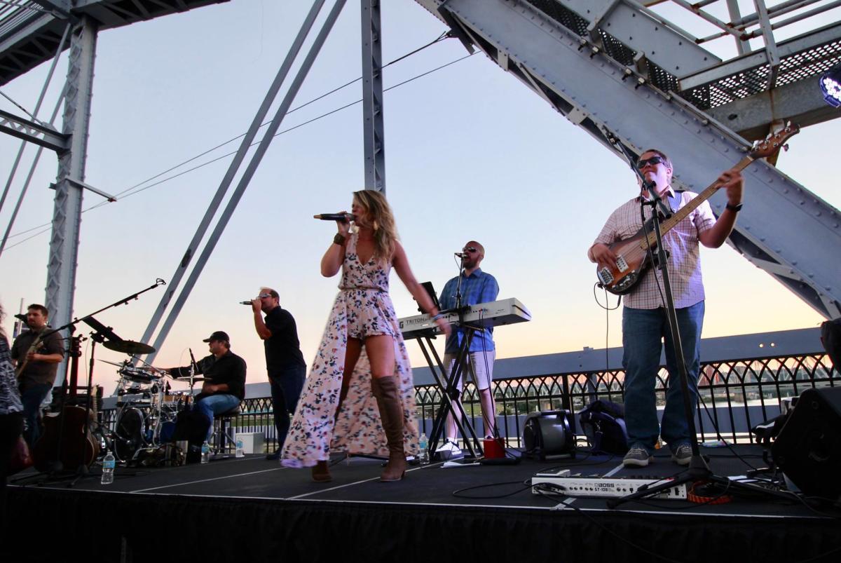 band playing and woman singing on the purple people bridge in newport ky