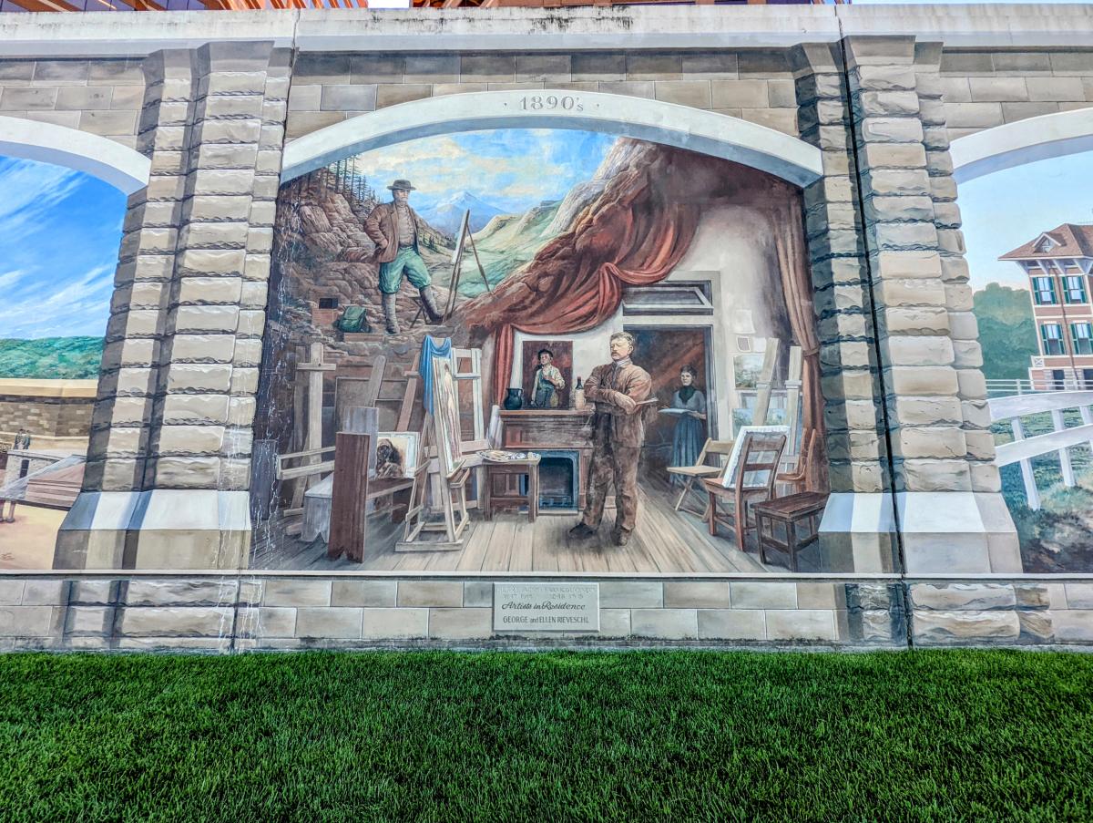 A Dafford mural of the artists Frank Duveneck and Henry Farny in a studio surrounded by art