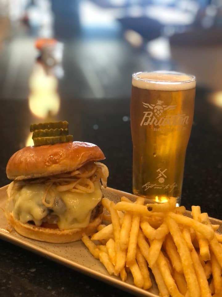 burger from kitchen 1883 with braxton brewing co beer in background