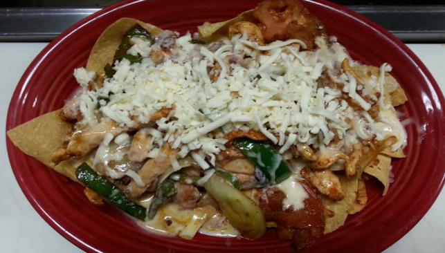 A plate of nachos from El Puente Latin Grill