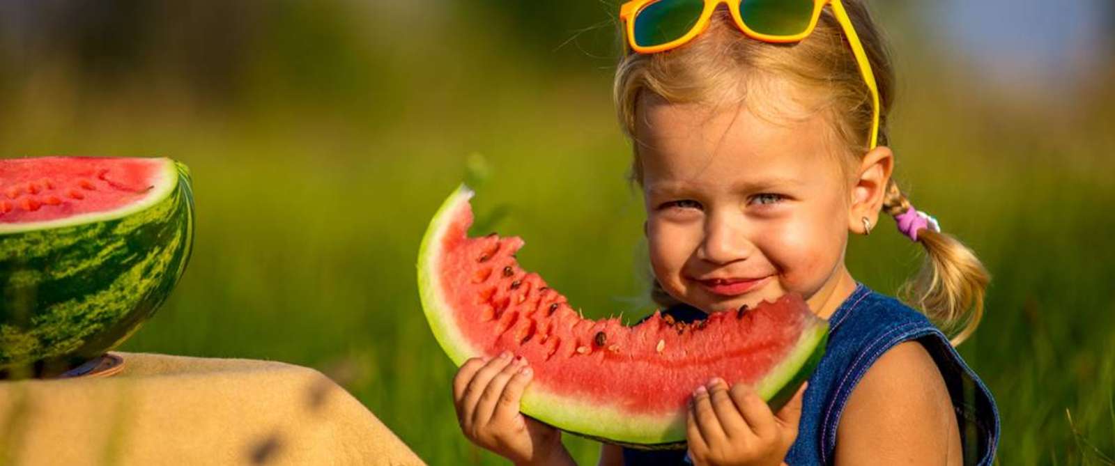 Little Girl Eating A Slice Of Watermelon