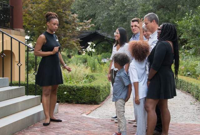 A group listens to a guide share the history of Columbia, South Carolina.