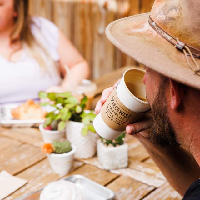 People drinking coffee on a patio