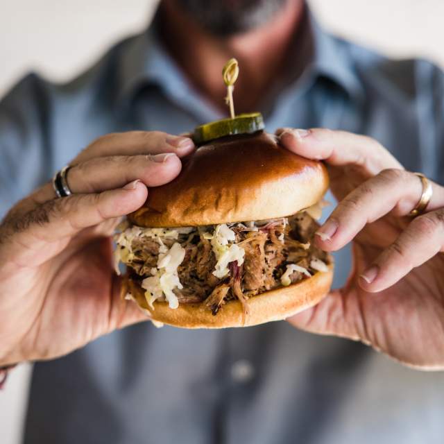 Man holding BBQ Sandwich
