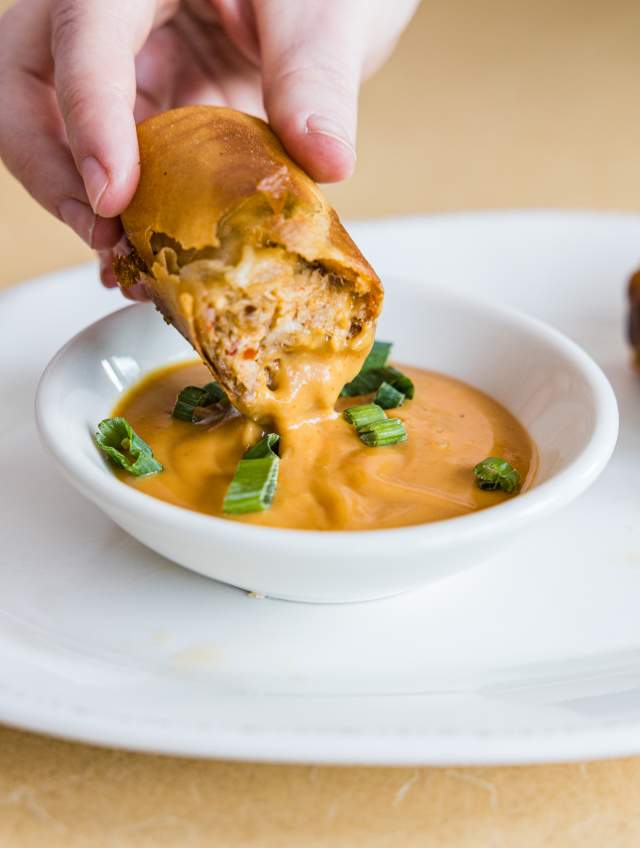 Egg roll dipped into bbq sauce