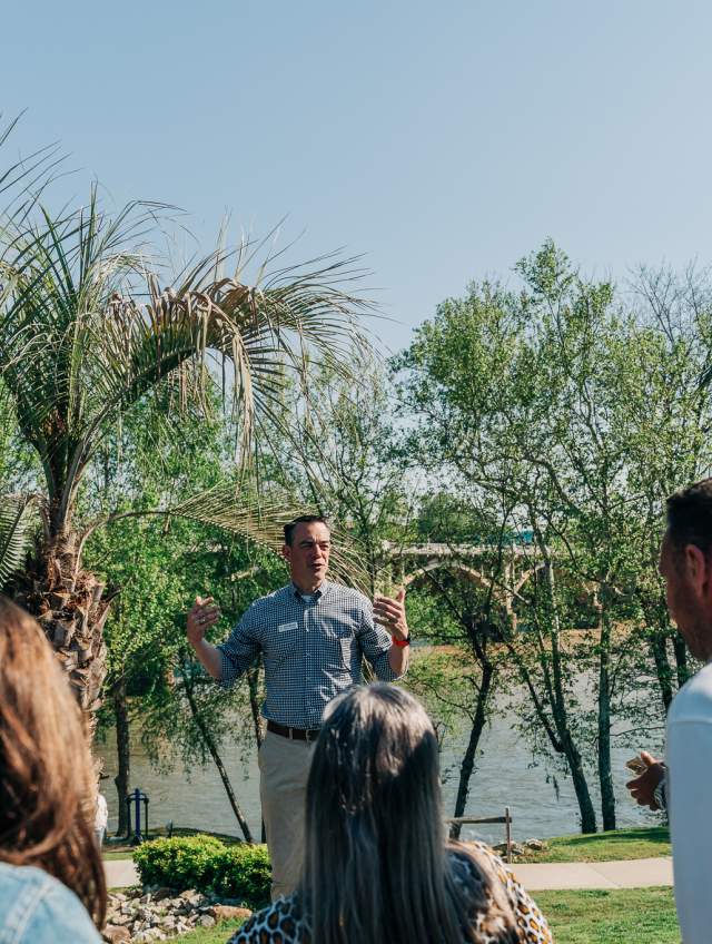 Man giving tour in front of river