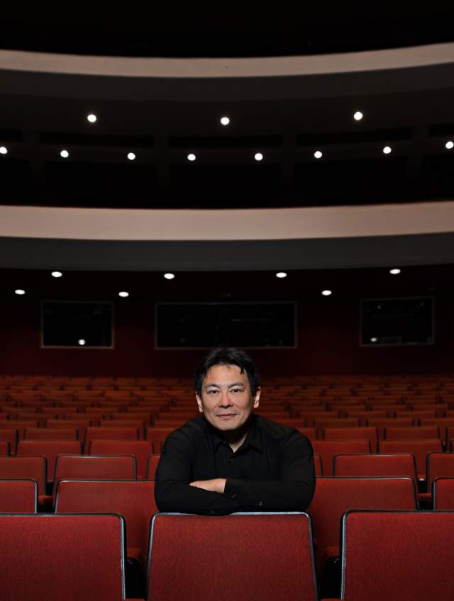 Morihiko Nakahara sitting in an empty theater