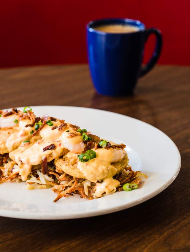 Hash browns topped with fried green tomatoes and pimento cheese