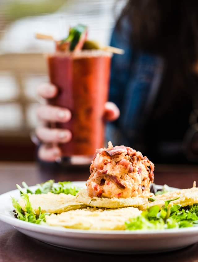 Scoop of Pimento Cheese on top of Fried Green Tomatoes