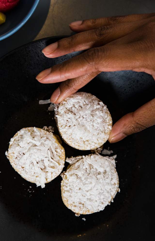 3 cookies with a hand reaching in to take one
