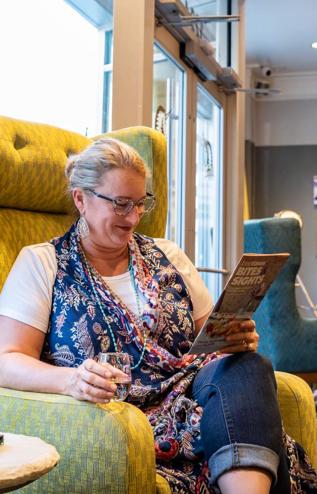 Vanessa reading in the Hotel Trundle Lobby