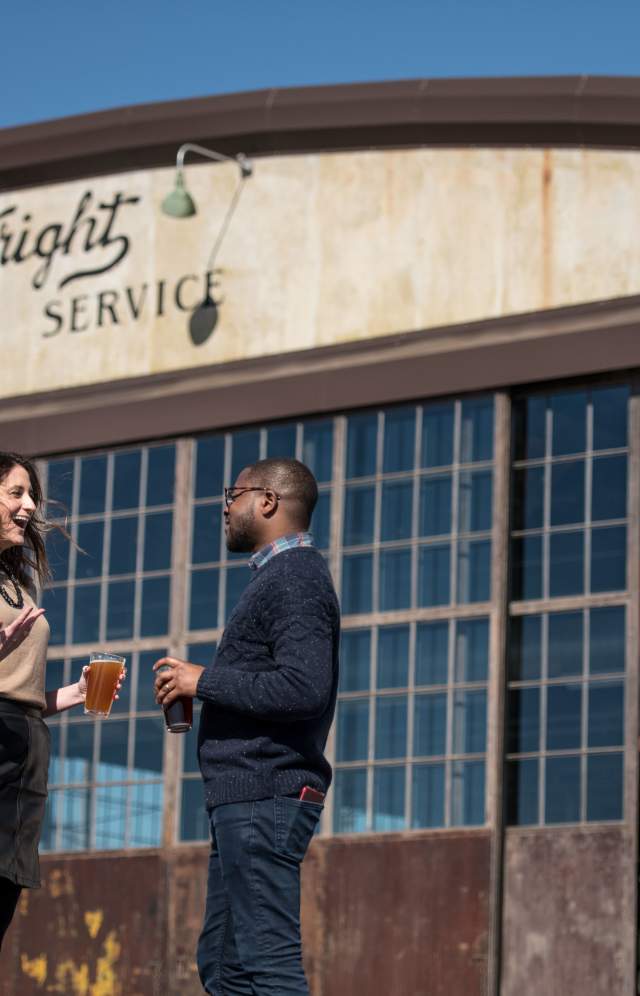 Couple drinking beer at the Curtis Wright Hangar