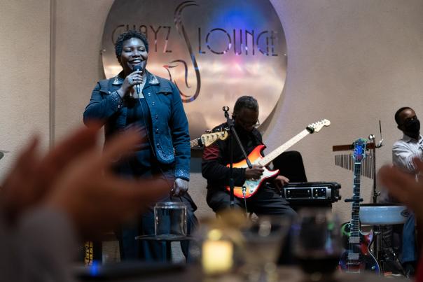 Woman speaking on stage in a jazz bar