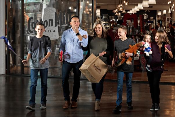 Family leaving gift shop with shopping bags