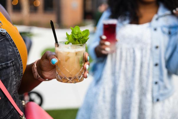 Two women holding pink cocktails