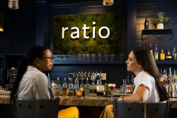 Two women sitting at a cocktail bar