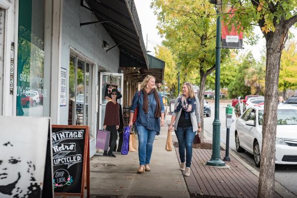 Woman walking past shops