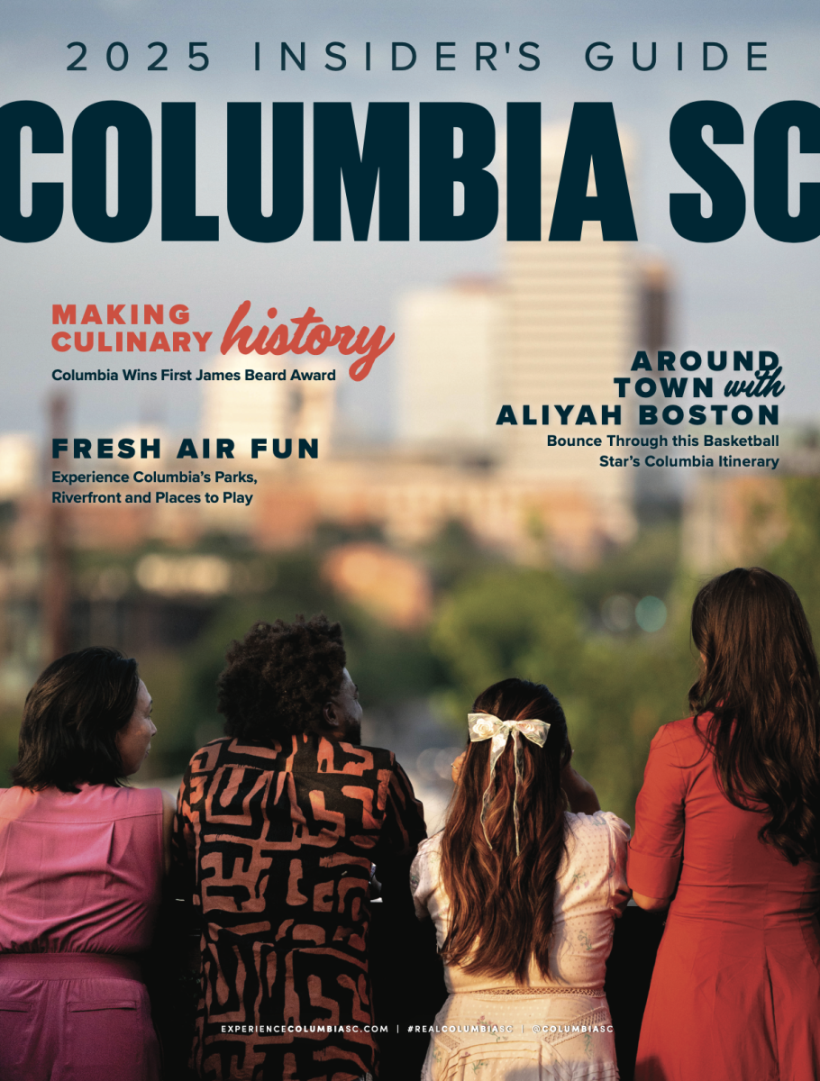 Magazine cover with 4 people looking out over a skyline