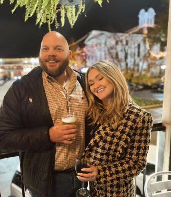 David and his wife, Chloe, on the balcony of City Grocery with the Oxford Square in the background.