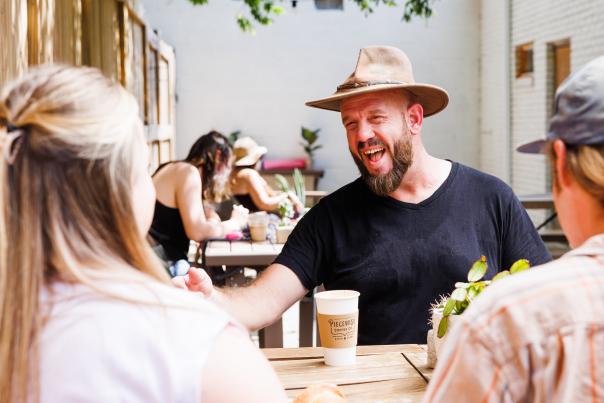 People drinking coffee on a patio