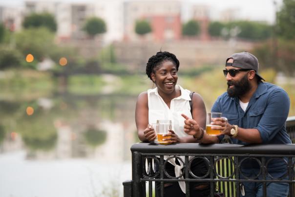 Couple drinking beers outside