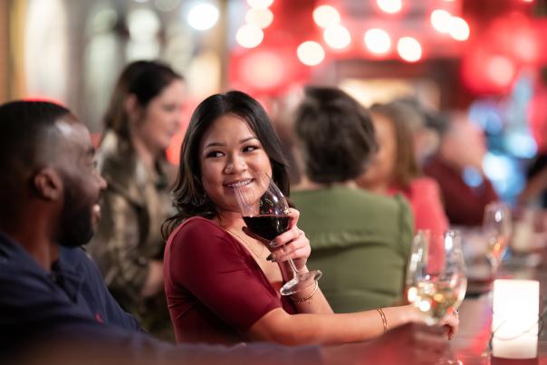 Couple sitting at a bar drinking wine
