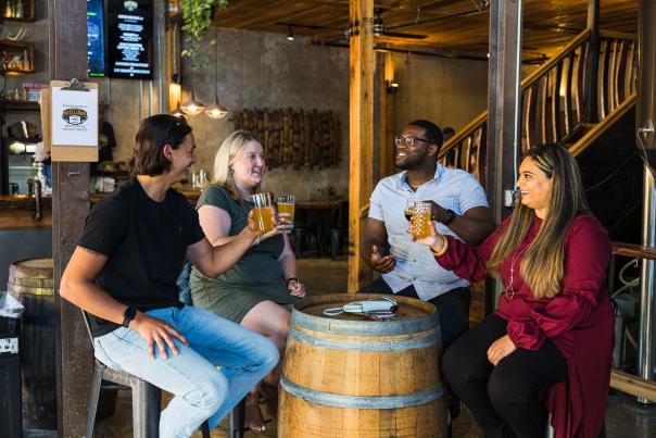 Young adults drinking beer at a brewery