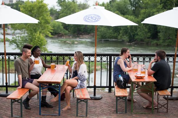 People drinking beer by a river