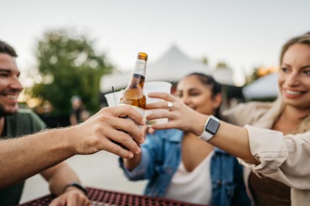 Three people cheers with beer