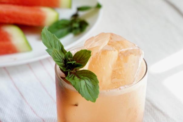 Cocktail with watermelon, gin bottle and basil