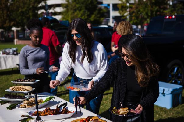 Gamecock fans getting food at a tailgate table