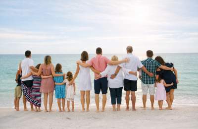a reunion of people on the beach looking out over the ocean