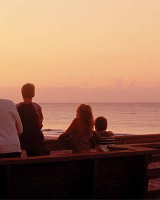 Family watching the sun set
