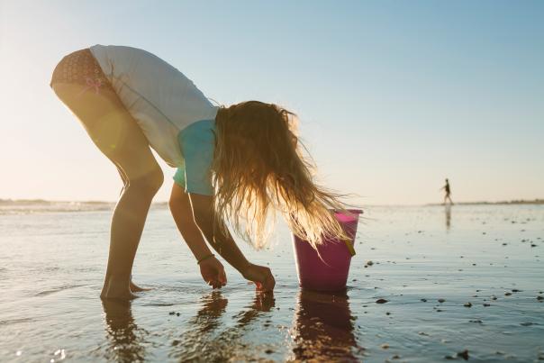 Kid picking up shells