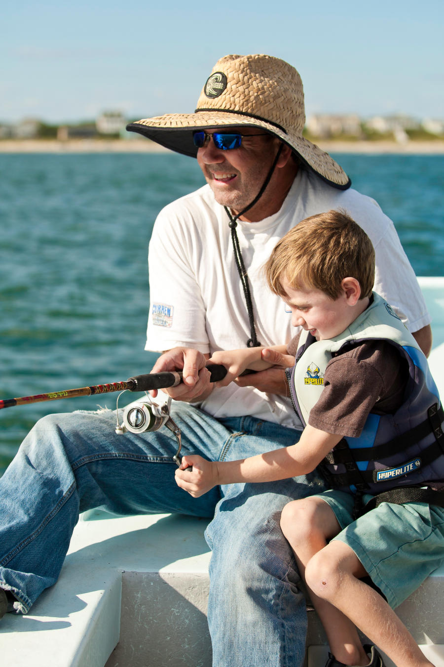 Father and son fishing on a boat together