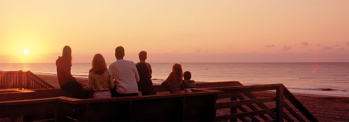 Family watching the sun set