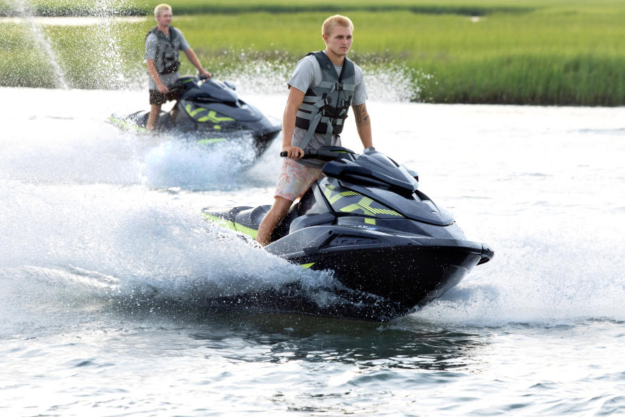 two people riding jet skis