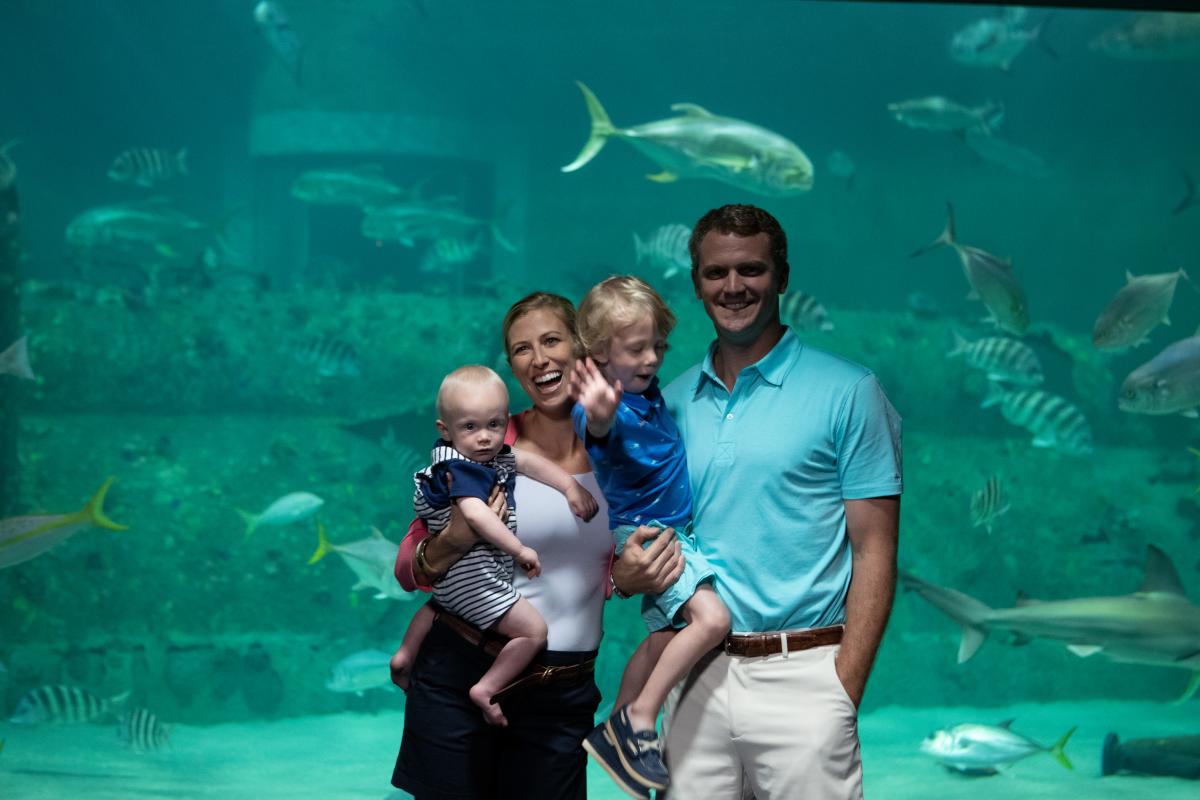 family with small kids at aquarium