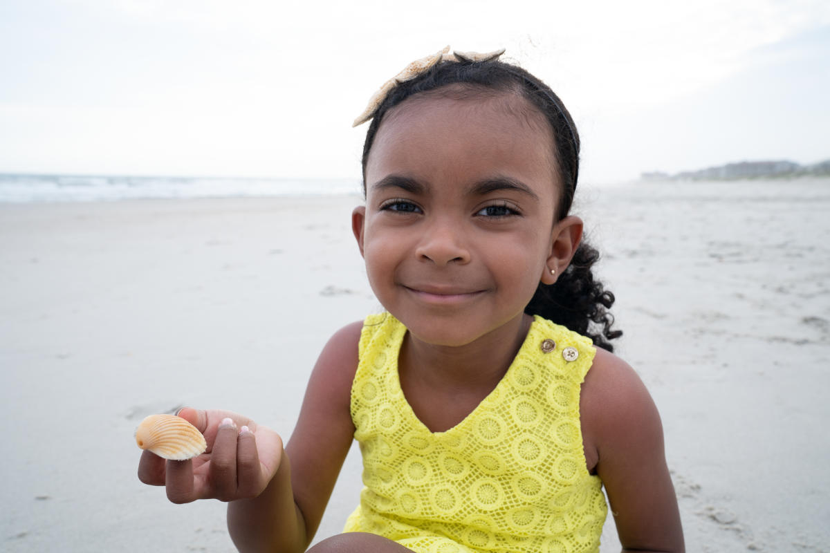 Girl with Shell on Beach