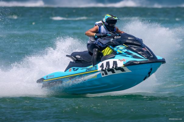 Person, in a competition, on a jet ski in the ocean off of Daytona Beach.