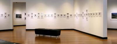 A gallery at the Southeast Museum of Photography with a bench and small photos on the wall.