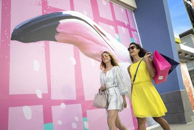 Two smiling shoppers at One Daytona in Daytona Beach