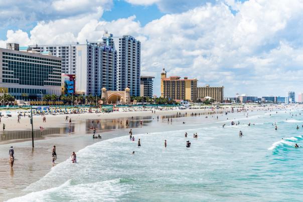 Visitors to Daytona Beach in the Atlantic Ocean by the Boardwalk and Pier.